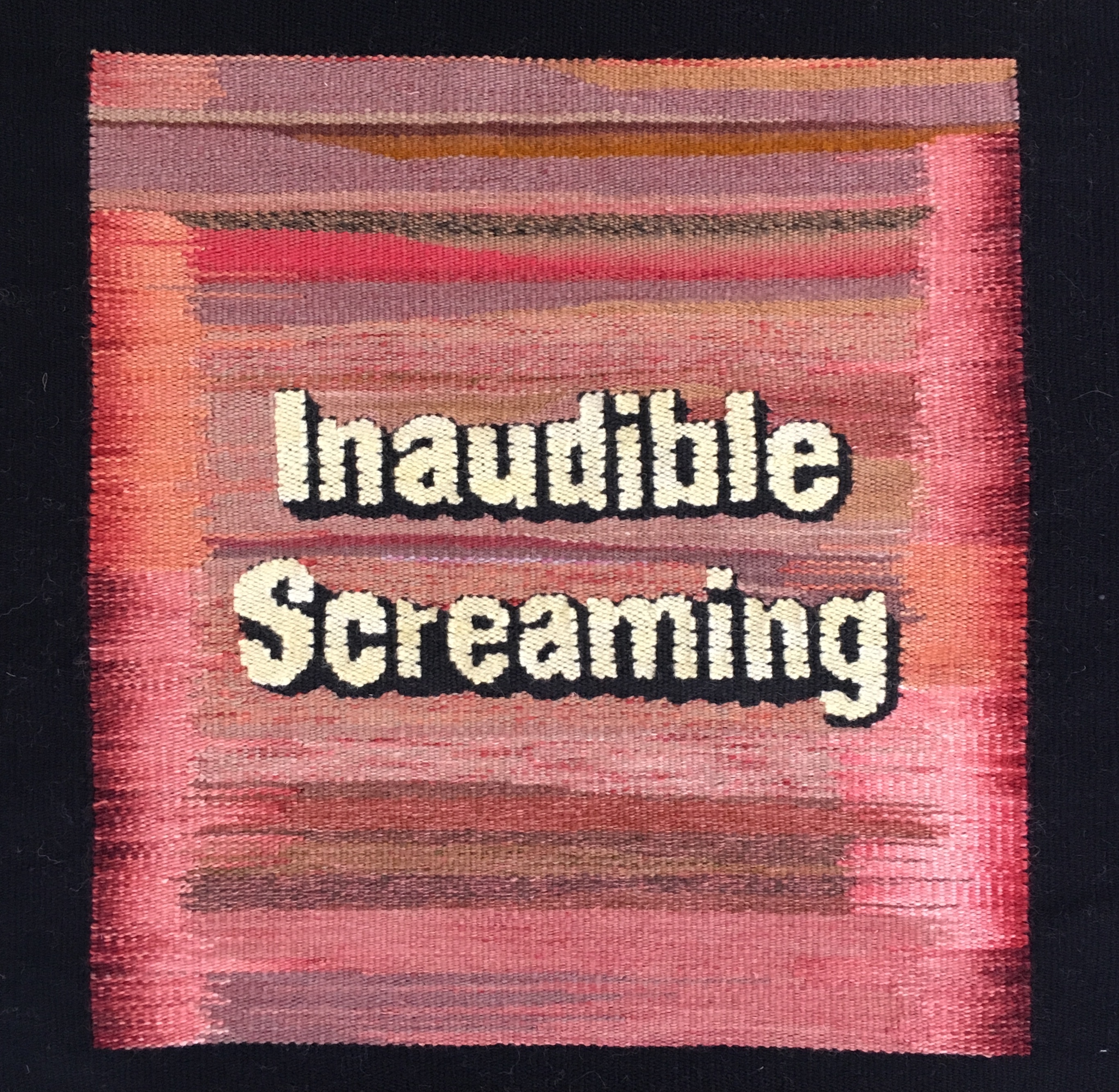 A square tapestry in hues of pink with the words 'Inaudible Screaming' across it